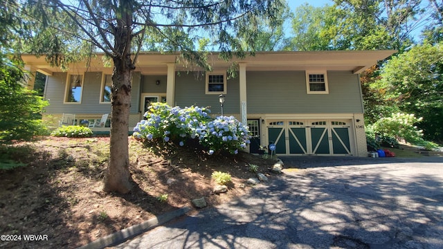 view of front facade with a porch and a garage