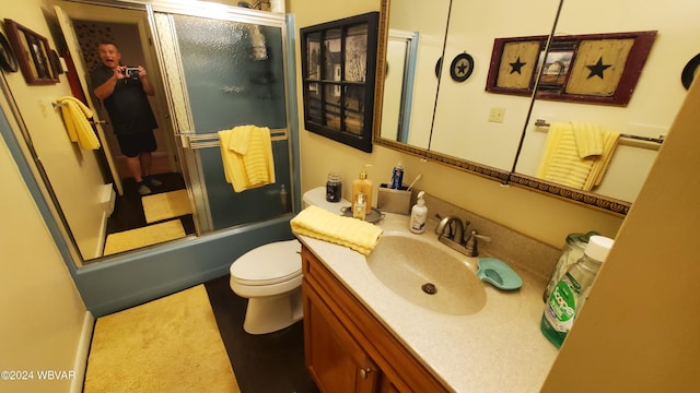 full bathroom with vanity, shower / bath combination with glass door, and toilet