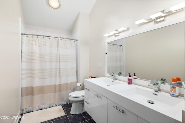 bathroom featuring tile patterned flooring, vanity, and toilet