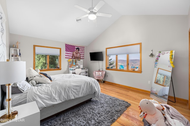 bedroom with ceiling fan, wood-type flooring, and vaulted ceiling