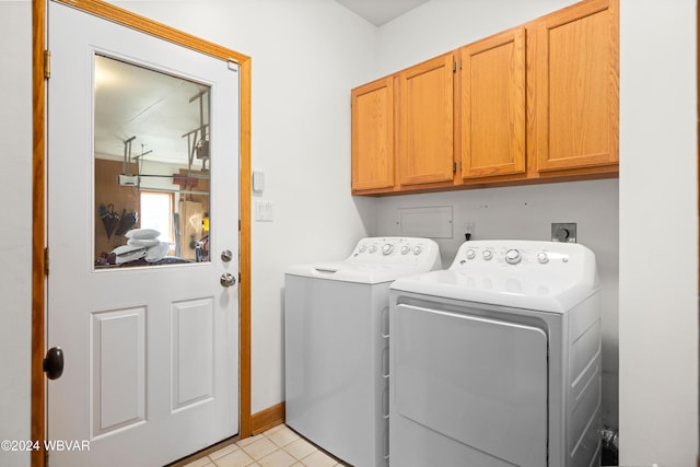 laundry area with washer and dryer and cabinets