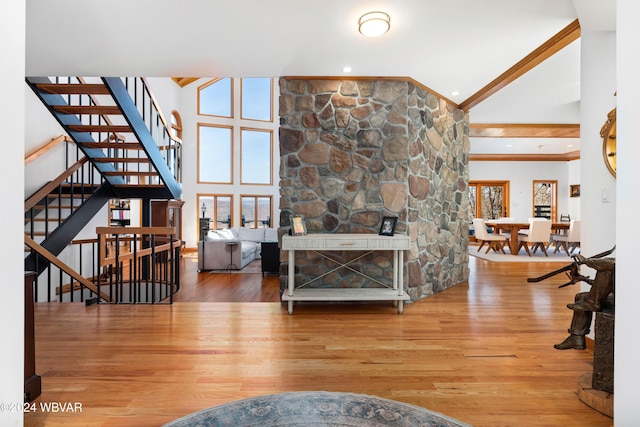 living room featuring beamed ceiling, wood-type flooring, and high vaulted ceiling