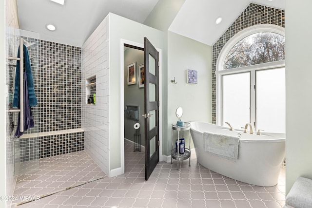 bathroom featuring separate shower and tub and lofted ceiling