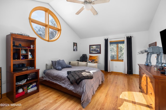 bedroom with ceiling fan, light hardwood / wood-style flooring, and vaulted ceiling