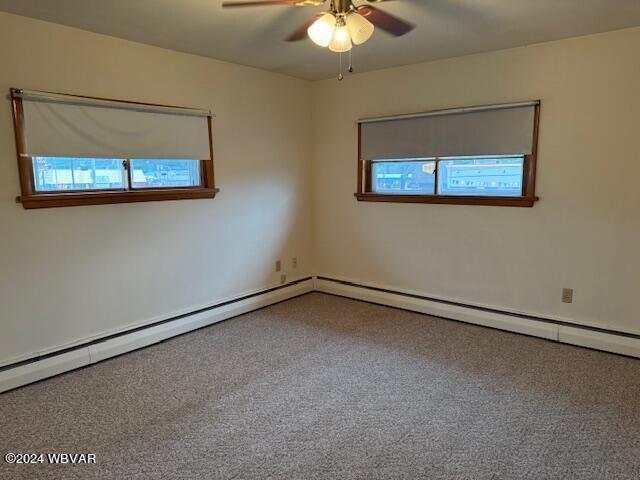 carpeted empty room featuring ceiling fan