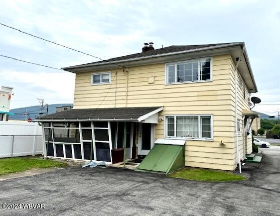 back of property featuring a sunroom