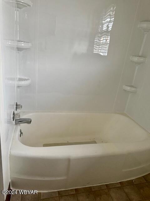 bathroom featuring shower / bathing tub combination and tile patterned floors