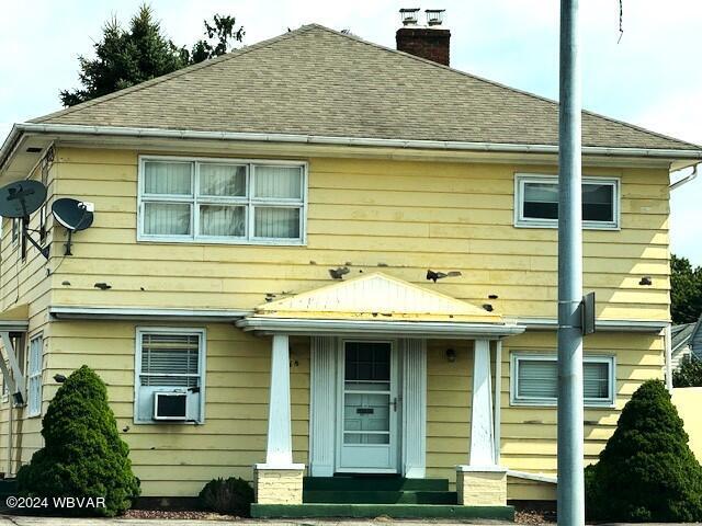 rear view of property with a porch