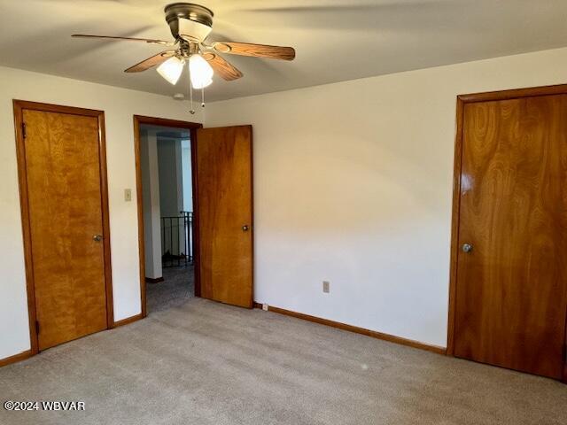 unfurnished bedroom with ceiling fan and light carpet