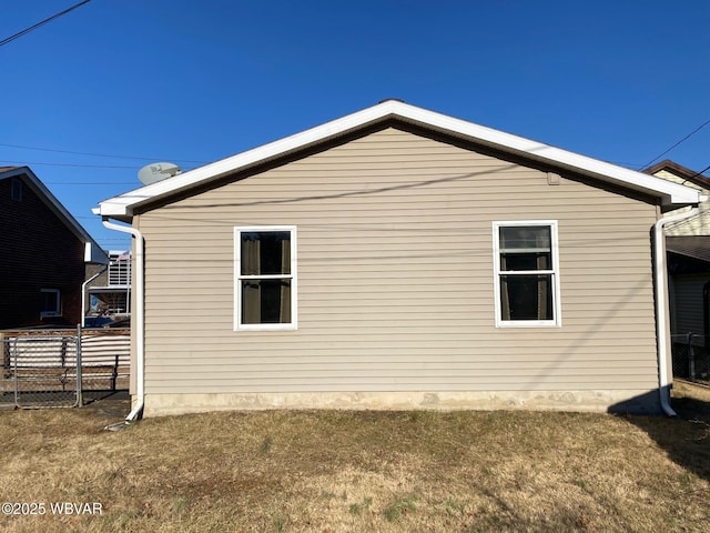 view of home's exterior featuring fence