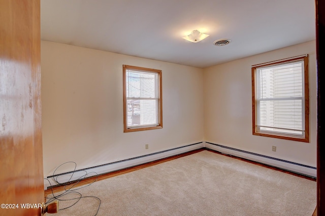 65 Spring St, Lock Haven, PA 17745 - carpeted empty room with a baseboard heating unit and baseboards
