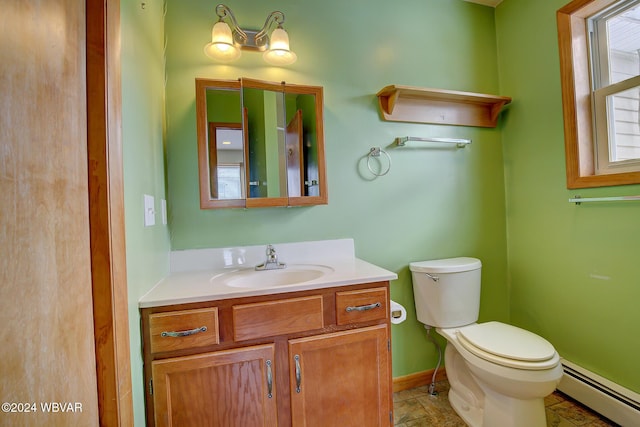 half bath featuring toilet, a baseboard radiator, baseboards, and vanity