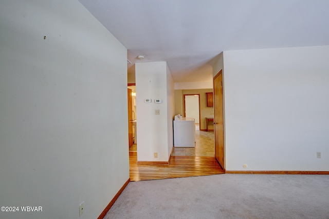 spare room with light wood-type flooring and washer / dryer