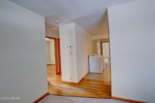 65 Spring St, Lock Haven, PA 17745 - hallway with separate washer and dryer, a baseboard heating unit, and light wood-style floors