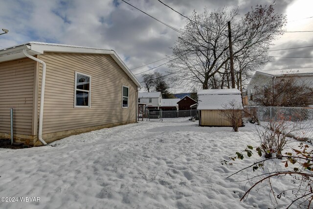 65 Spring St, Lock Haven, PA 17745 - yard layered in snow with a storage shed and a fenced backyard