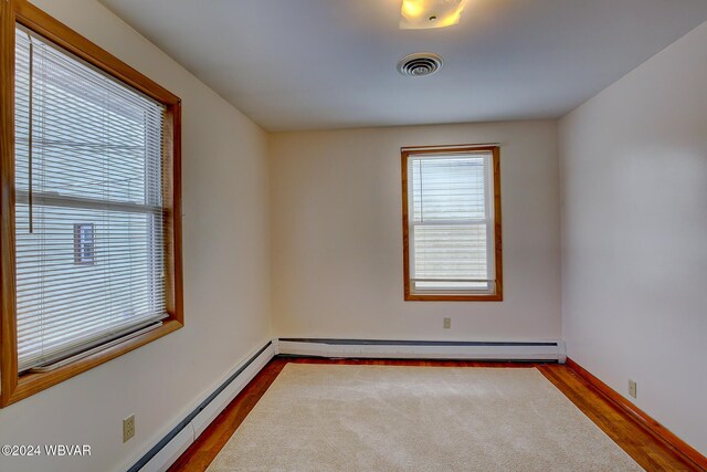 65 Spring St, Lock Haven, PA 17745 - empty room featuring baseboard heating and dark wood-style flooring