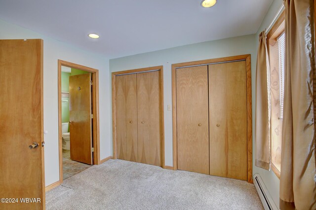 65 Spring St, Lock Haven, PA 17745 - unfurnished bedroom featuring carpet, multiple closets, a baseboard radiator, connected bathroom, and recessed lighting
