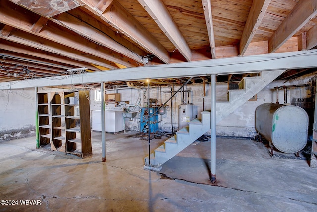 unfinished below grade area with separate washer and dryer, water heater, stairs, heating fuel, and a heating unit