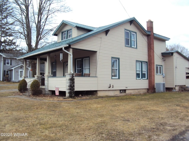 view of property exterior featuring a porch, a lawn, a chimney, and central air condition unit