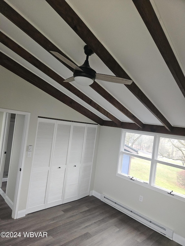 unfurnished bedroom featuring dark hardwood / wood-style flooring, vaulted ceiling with beams, baseboard heating, and ceiling fan