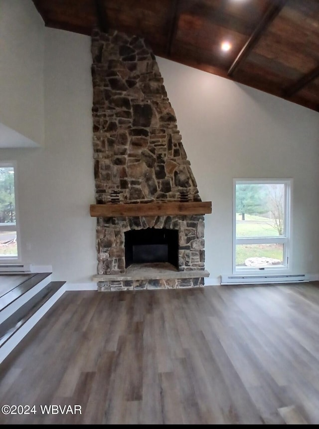 unfurnished living room with a stone fireplace, high vaulted ceiling, wooden ceiling, and hardwood / wood-style flooring