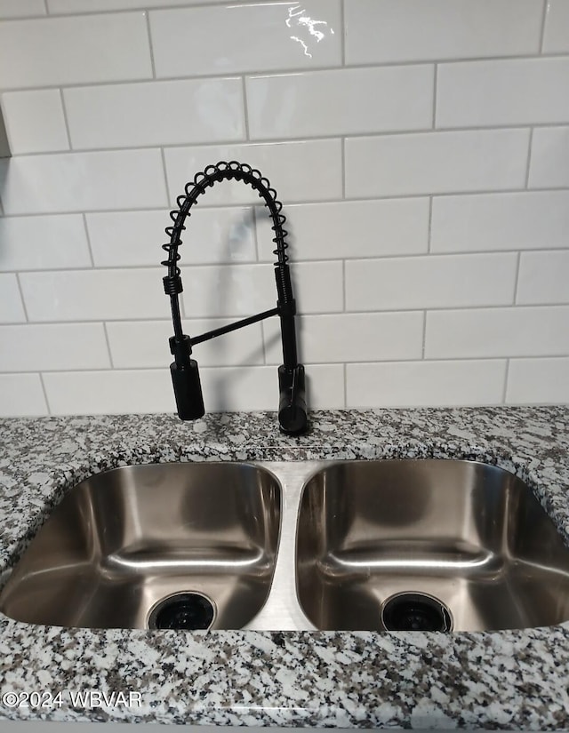 room details featuring sink and stone countertops