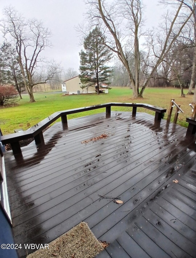 wooden deck featuring a yard