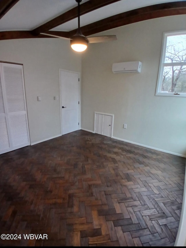 spare room with lofted ceiling with beams, a wall unit AC, and dark parquet floors