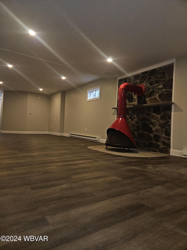 basement featuring dark hardwood / wood-style floors and a baseboard radiator