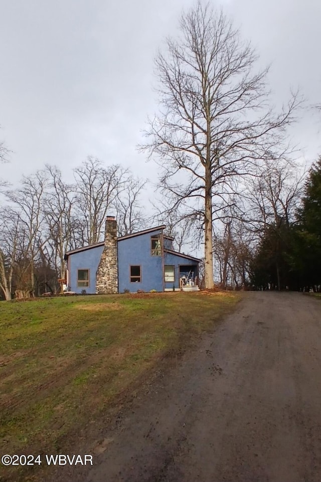 view of side of home featuring a lawn