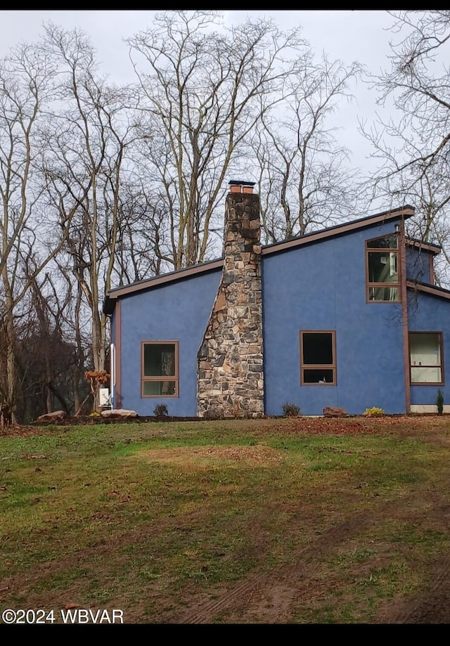 view of home's exterior with a yard