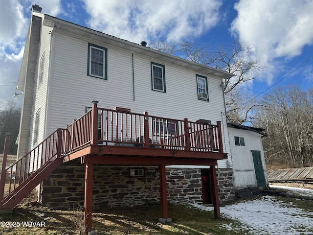 back of property featuring stairs, a wooden deck, and a chimney