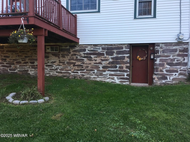 doorway to property featuring a yard