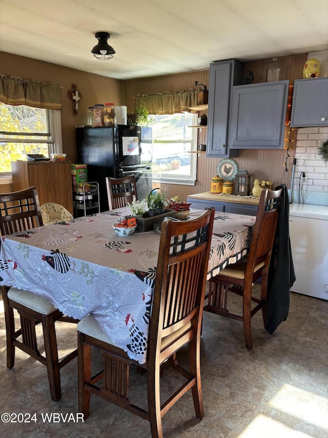 dining room featuring wooden walls