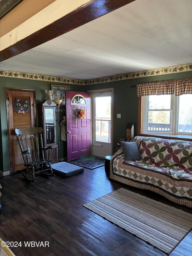 living room featuring beamed ceiling and wood-type flooring