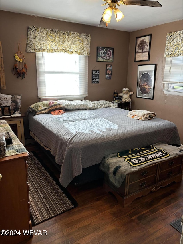 bedroom with ceiling fan and dark hardwood / wood-style flooring