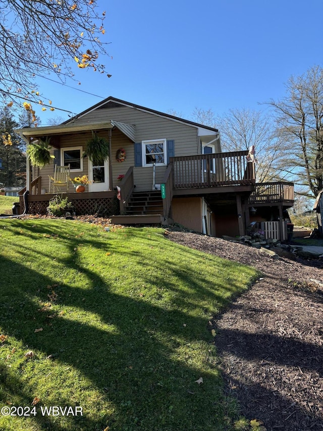 rear view of property with a lawn and a wooden deck