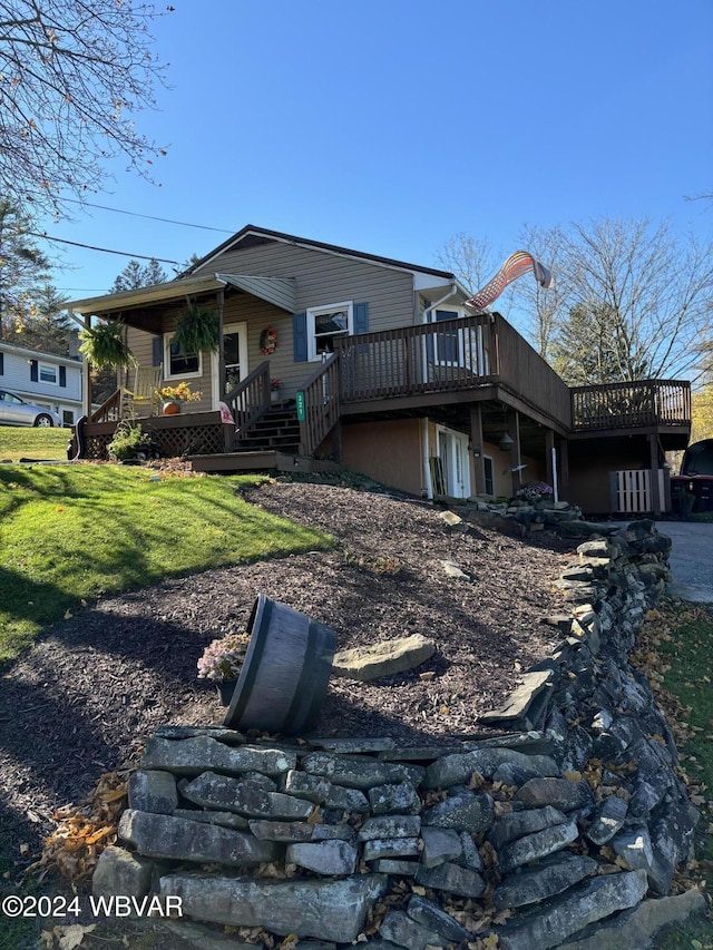 back of house with a yard and a deck