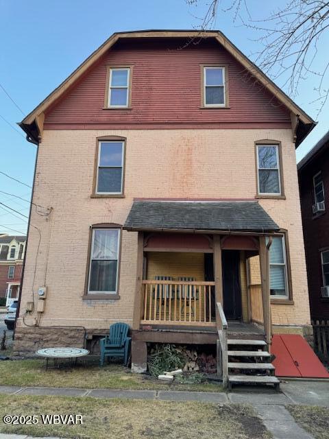 view of front of property with brick siding and covered porch