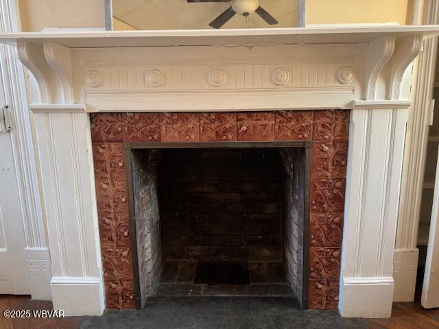 interior details with a fireplace and ceiling fan