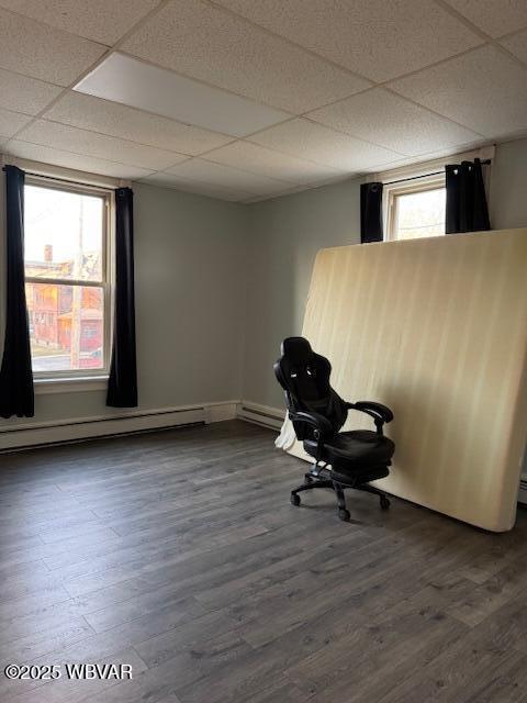 unfurnished office with dark wood-style floors and a drop ceiling