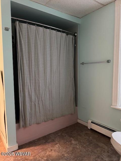 full bathroom featuring toilet, shower / bath combo with shower curtain, and a baseboard radiator