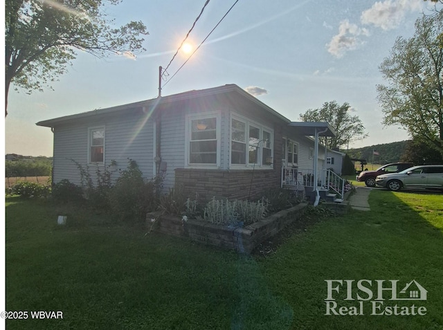 1520 Haagen Ln, Beech Creek, PA 16822 - view of home's exterior with a lawn and stone siding
