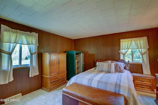 carpeted bedroom with wooden walls