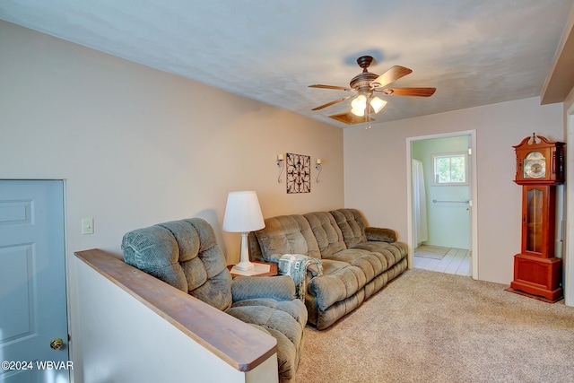 living room featuring ceiling fan and light colored carpet