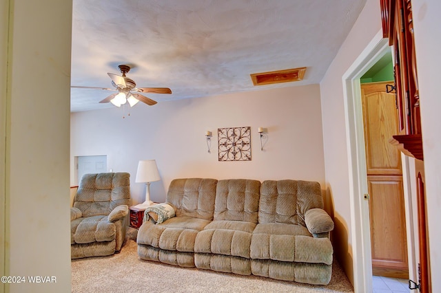 carpeted living room featuring ceiling fan