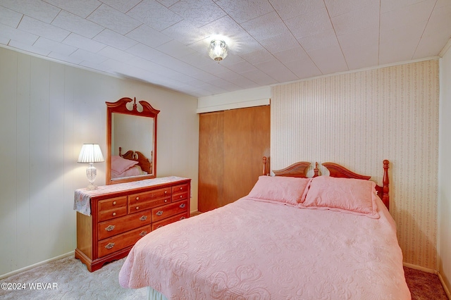 bedroom with a closet and light colored carpet