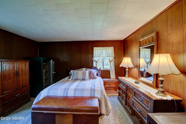 bedroom with wooden walls and carpet