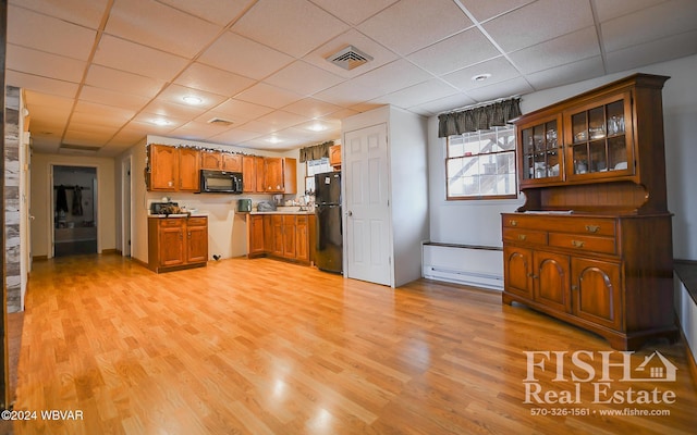 kitchen featuring a paneled ceiling, light hardwood / wood-style floors, a baseboard heating unit, and black appliances