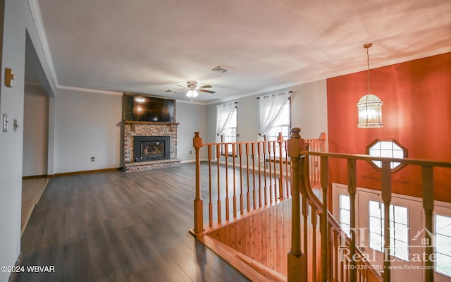 hall with dark hardwood / wood-style flooring, crown molding, and a chandelier